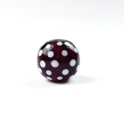 handgefertigte Glasperle lila Punkte